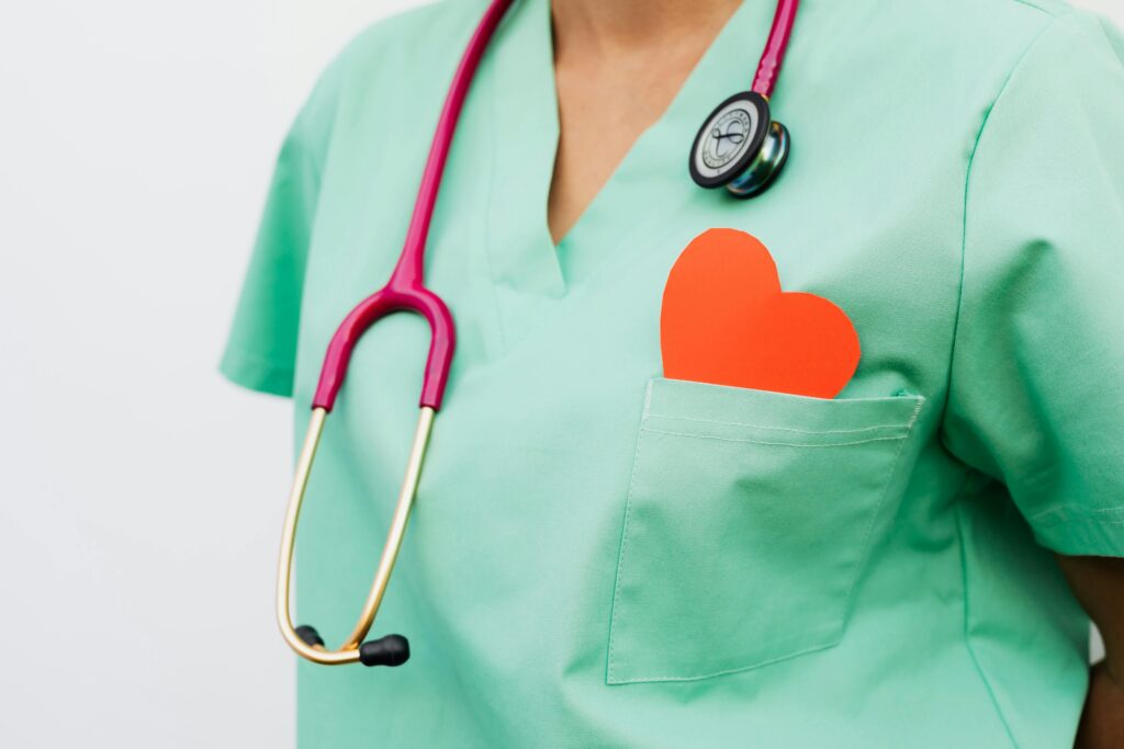 A healthcare professional with a stethoscope and red heart symbol emphasizes cardiology care.