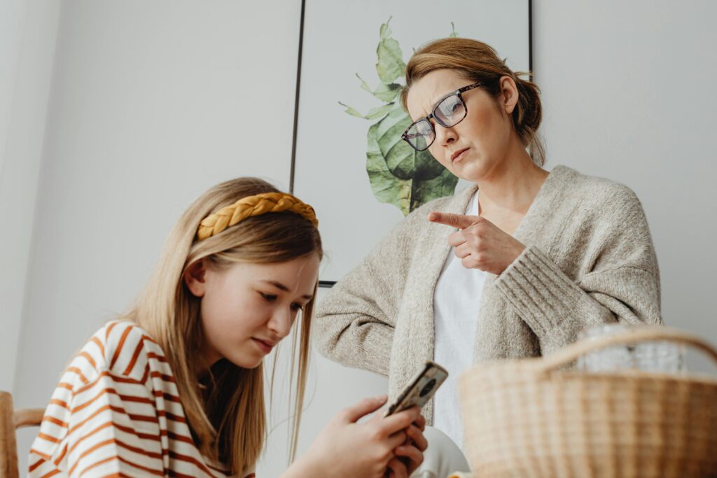 pexels-photo-6957246-6957246 A mother scolds her teenage daughter for excessive phone use at home.