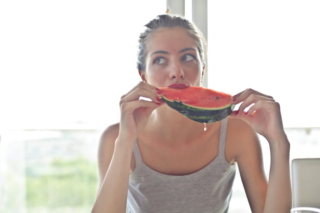 pexels-photo-768454-768454 Portrait of a woman eating watermelon indoors, reflecting health and summer vibes.