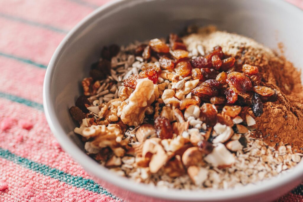 pexels-photo-1080105-1080105 A nutritious oatmeal bowl topped with walnuts, sunflower seeds, and raisins.