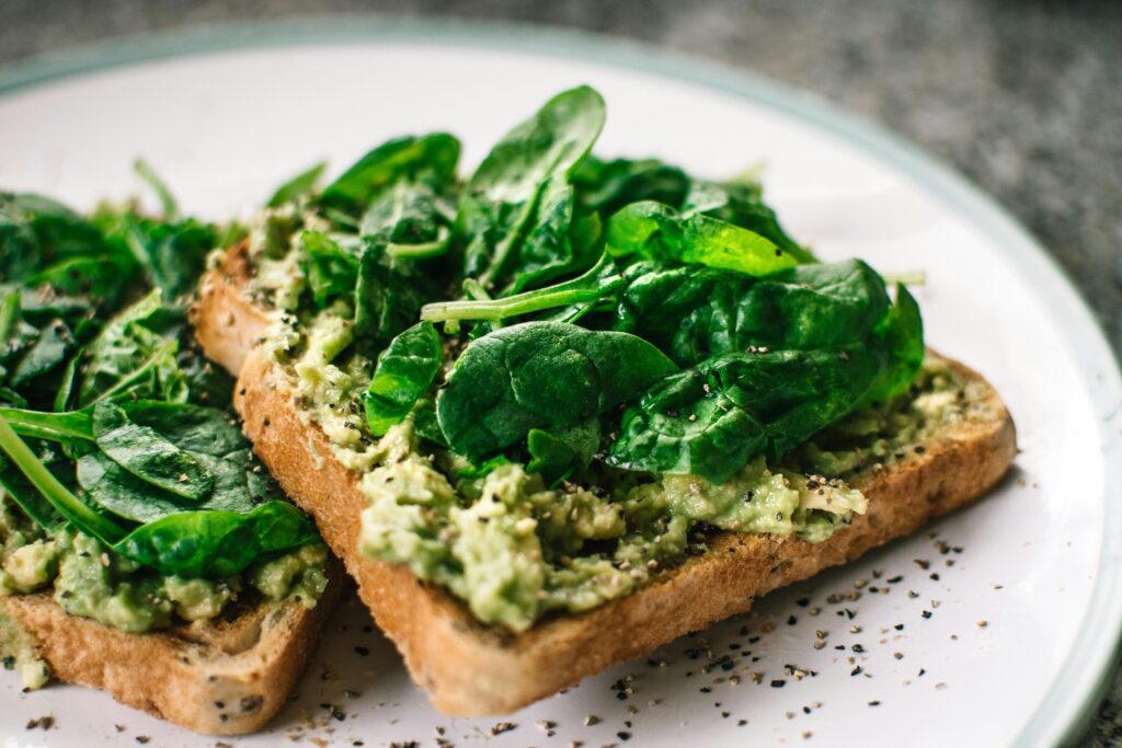 pexels-photo-1351238-1351238 Close-up of a homemade avocado and spinach sandwich on whole grain toast.